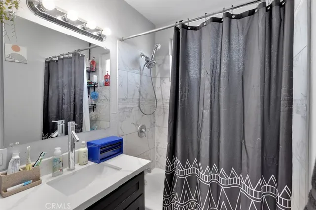 a en suite bathroom with a shower and a sink