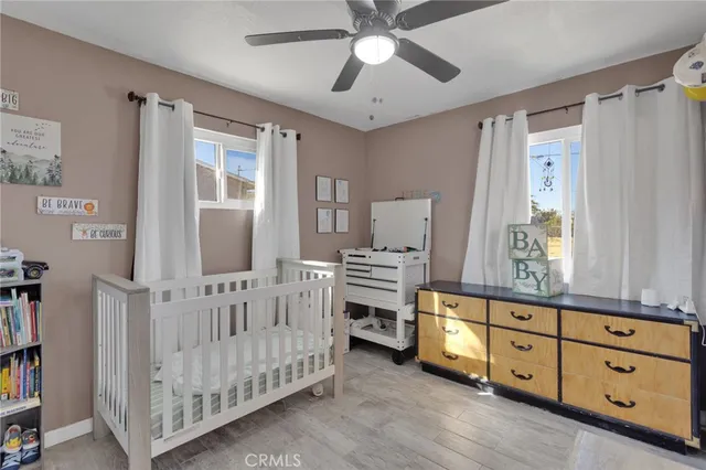 a bedroom with furniture and baby crib