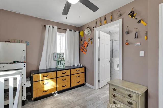 a spacious bedroom with a bed and a dresser