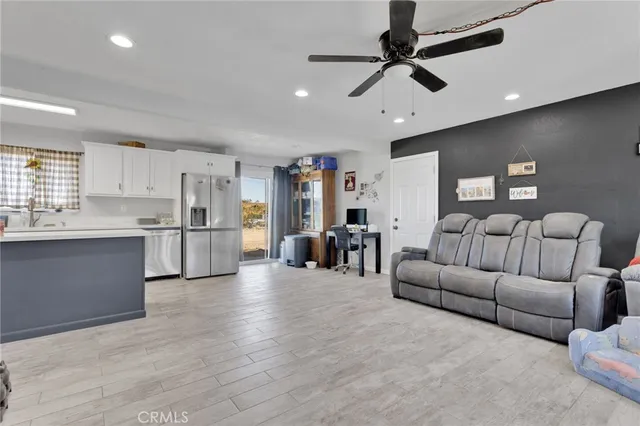 a kitchen with stainless steel appliances granite countertop a refrigerator and a stove top oven
