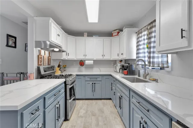 a kitchen with a sink stove and cabinets