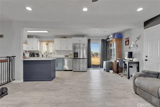 a kitchen with stainless steel appliances granite countertop a refrigerator and a stove top oven