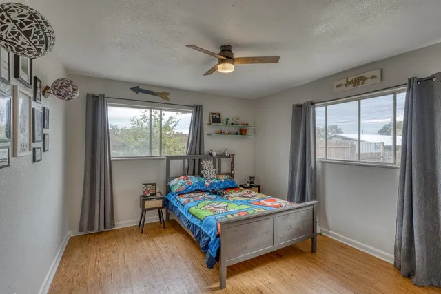 a bedroom with a bed and a window