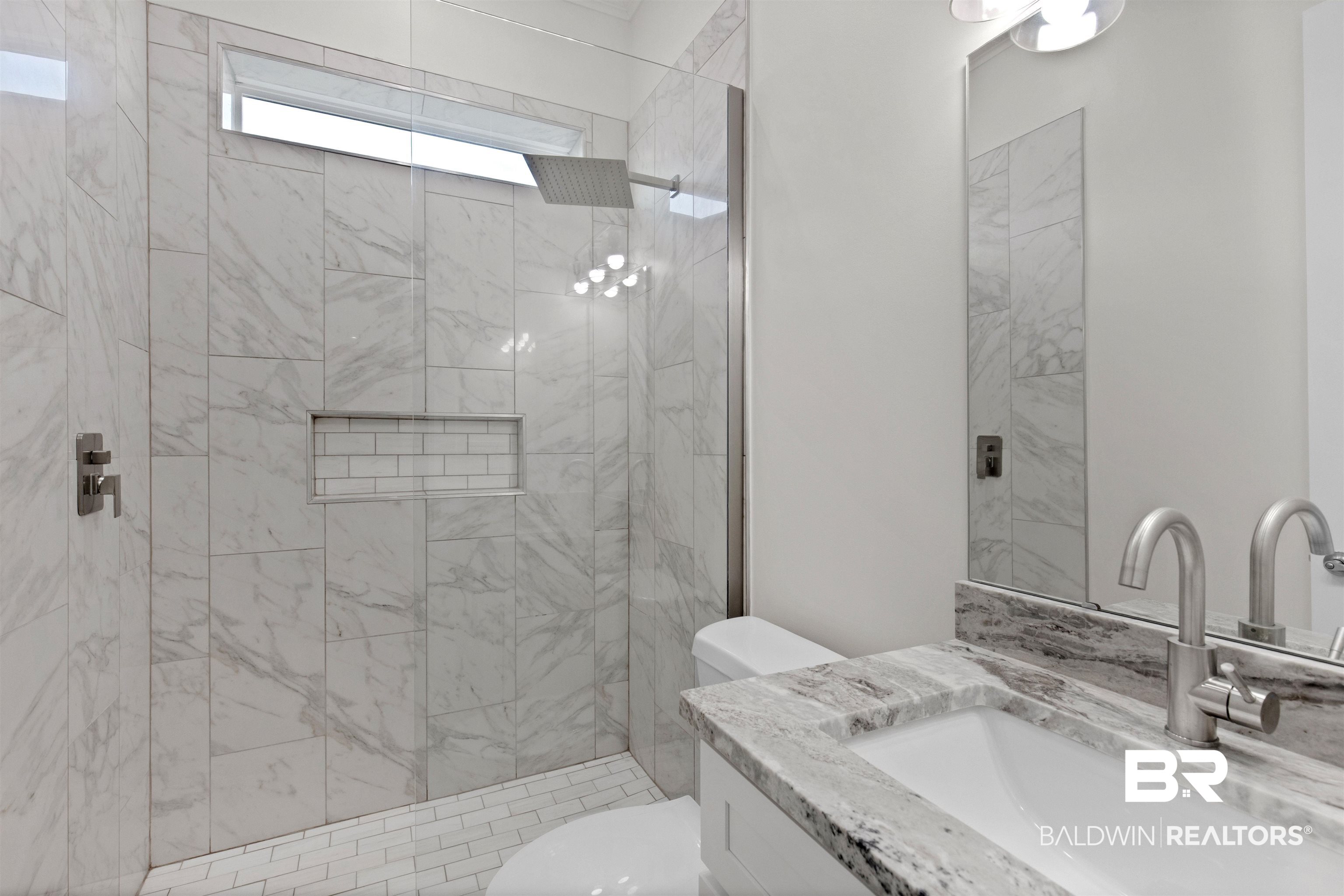 8069 Carmel Circle Foley, AL 36535 - Photo 12 of 23 Bathroom featuring toilet, vanity, and tiled shower