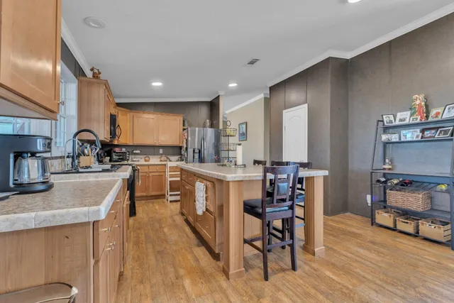 a kitchen with kitchen island granite countertop lots of counter top space and appliances