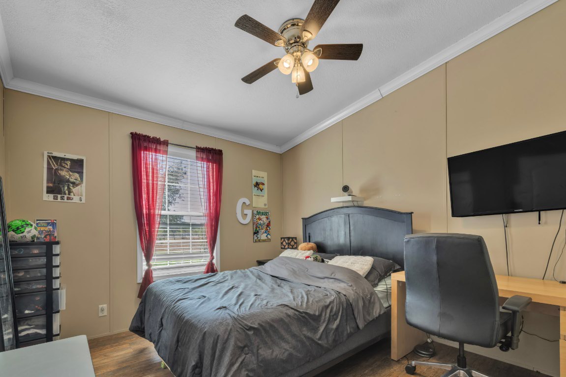 401 High Ridge Meadows Drive Gonzales, TX 78629 - Photo 18 of 31 a bedroom with a bed and a flat screen tv