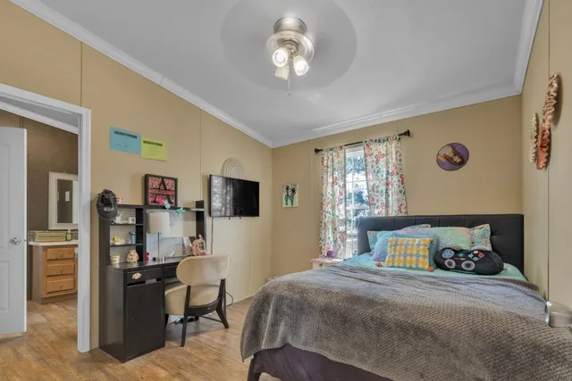 a bedroom with a bed and wooden floor