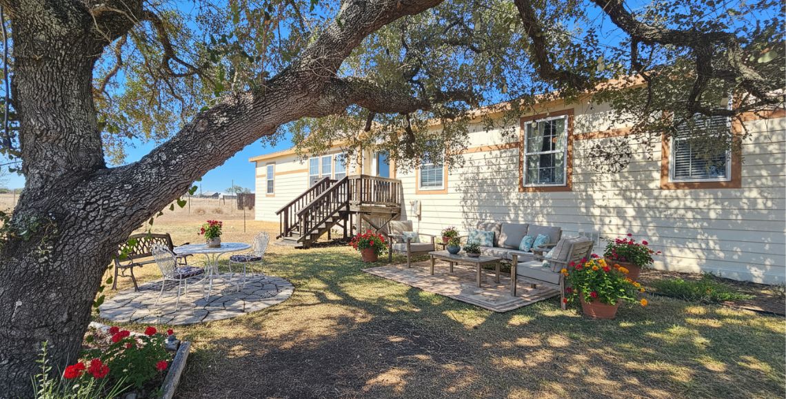 401 High Ridge Meadows Drive Gonzales, TX 78629 - Photo 2 of 31 a backyard of a house with outdoor seating