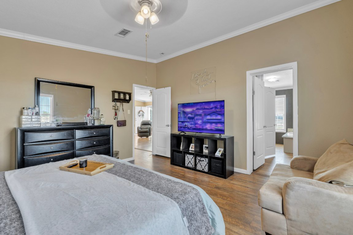 401 High Ridge Meadows Drive Gonzales, TX 78629 - Photo 6 of 31 a bedroom with furniture and a flat screen tv