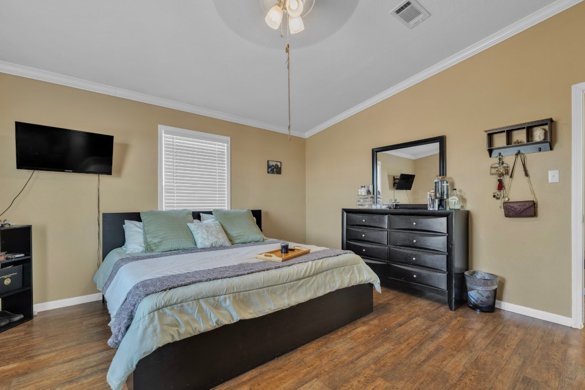 401 High Ridge Meadows Drive Gonzales, TX 78629 - Photo 7 of 31 a bedroom with a bed and a flat screen tv