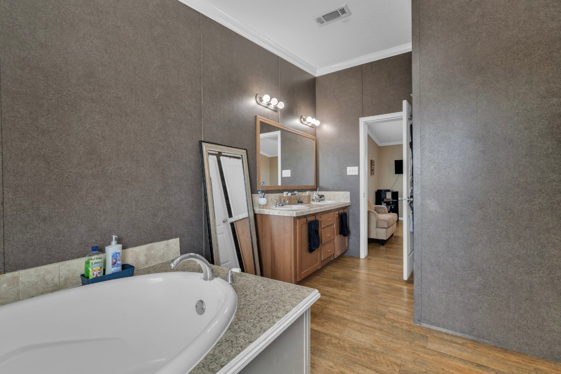 401 High Ridge Meadows Drive Gonzales, TX 78629 - Photo 9 of 31 a bathroom with a tub sink and mirror