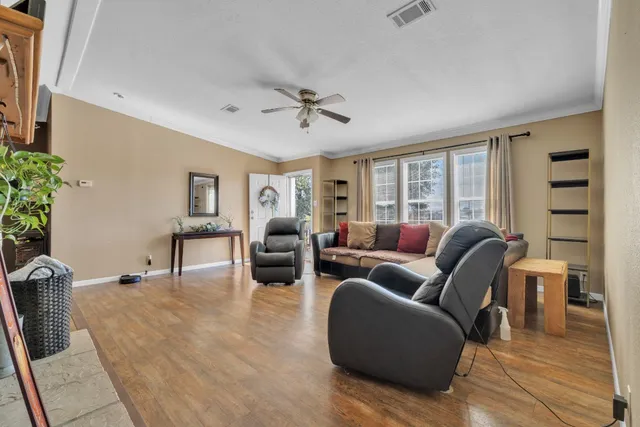 a living room with furniture and wooden floor