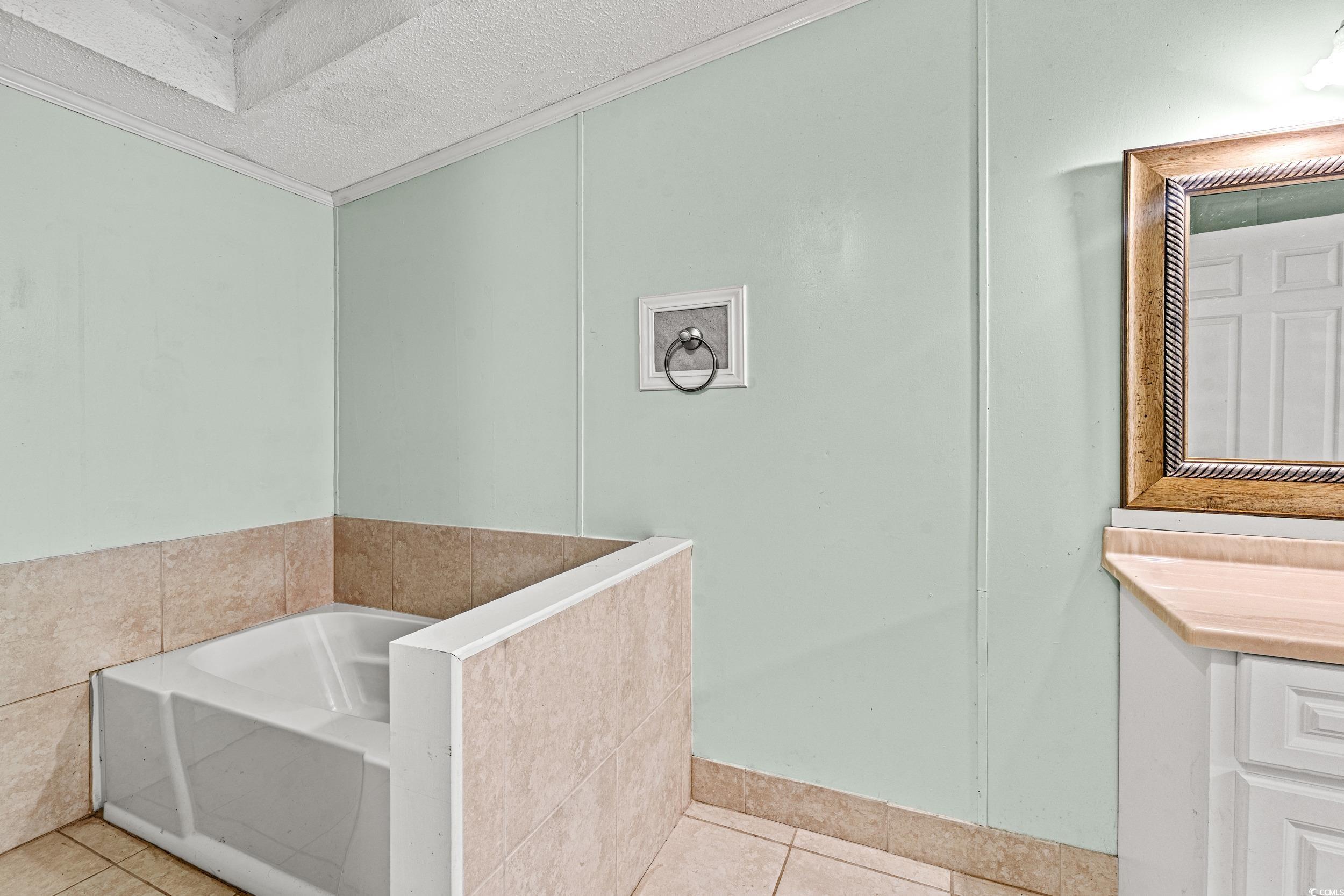 516 Grapevine Street Myrtle Beach, SC 29579 - Photo 15 of 33 Bathroom featuring tile patterned flooring, crown