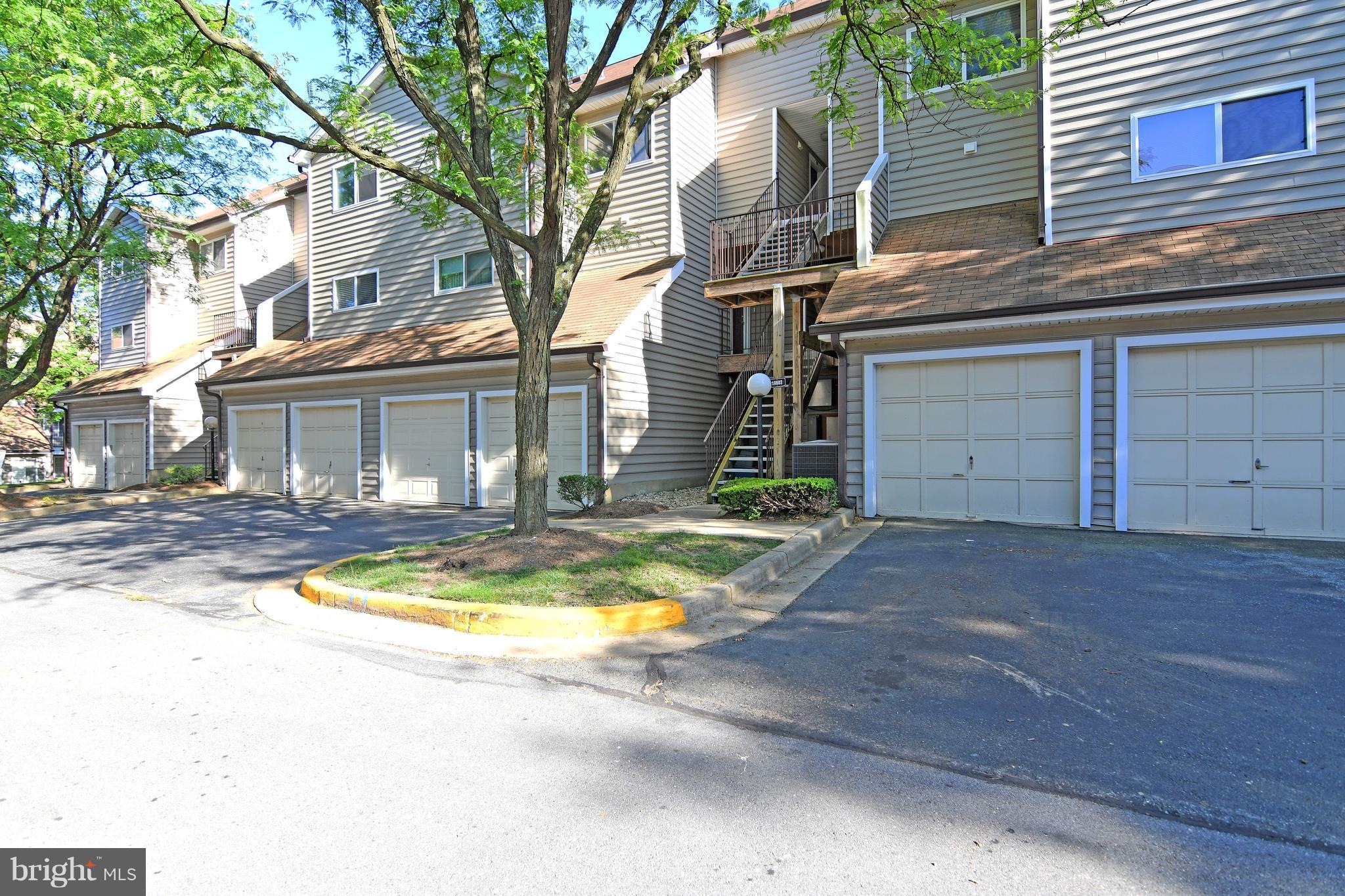 10803 Amherst Avenue, Unit F Silver Spring, MD 20902 - Photo 1 of 23 a view of a house with a swimming pool and a fire pit
