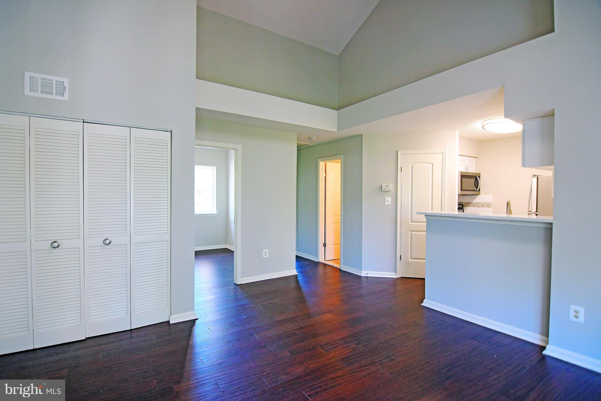 10803 Amherst Avenue, Unit F Silver Spring, MD 20902 - Photo 17 of 23 a view of a big room with wooden floor and windows