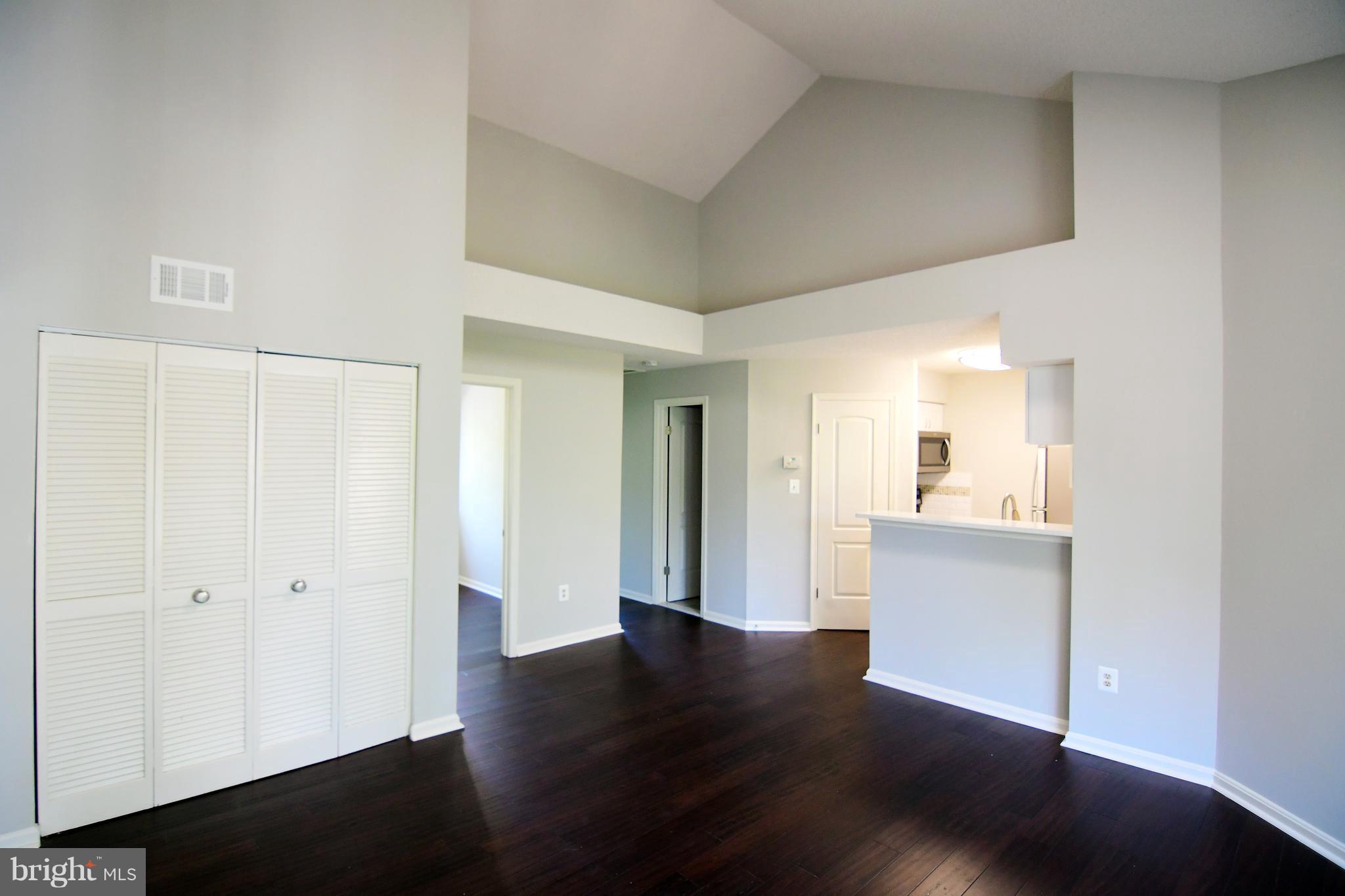 10803 Amherst Avenue, Unit F Silver Spring, MD 20902 - Photo 3 of 23 a view of a hallway with wooden floor