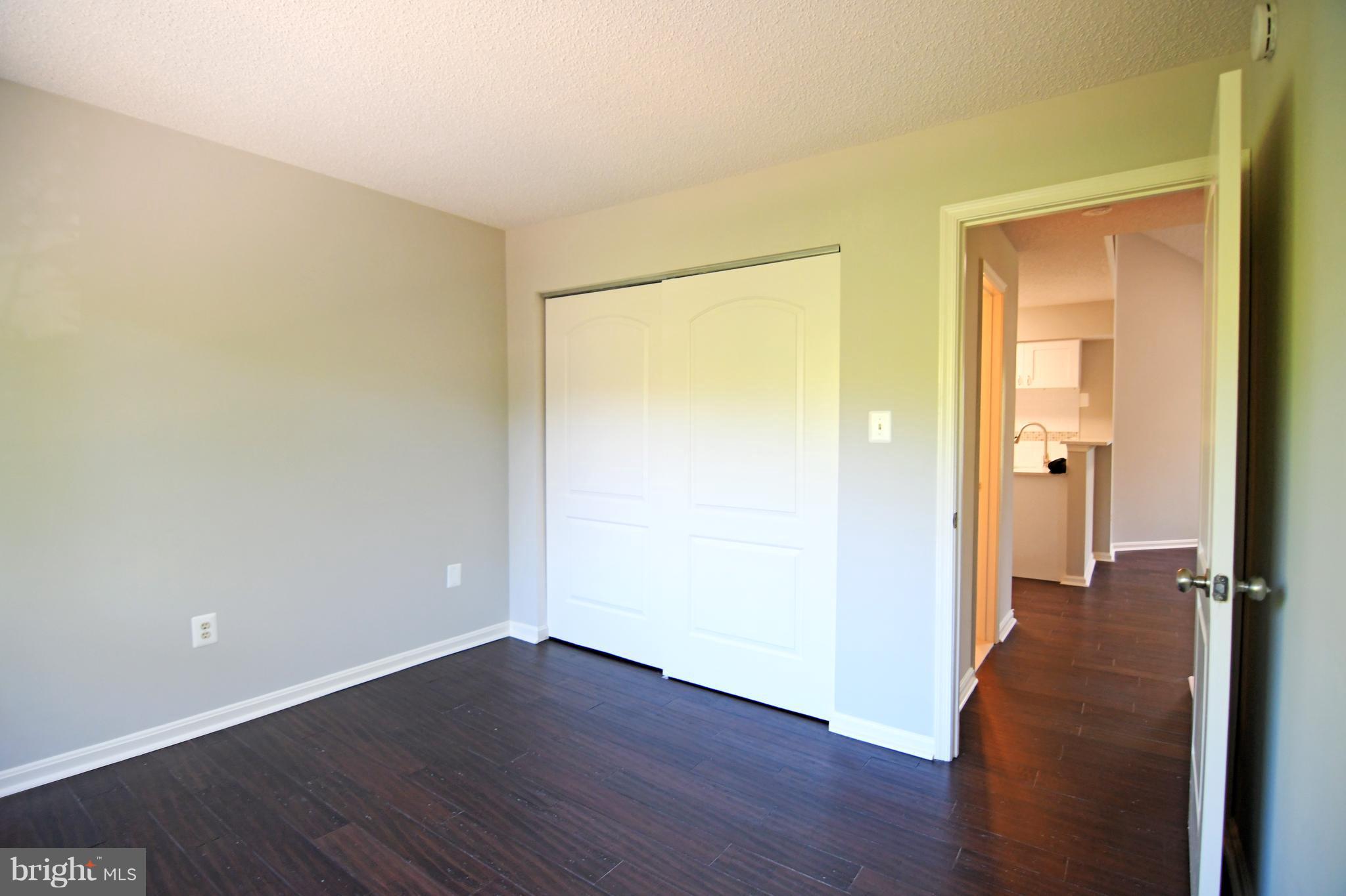 10803 Amherst Avenue, Unit F Silver Spring, MD 20902 - Photo 8 of 23 a view of a room with wooden floor