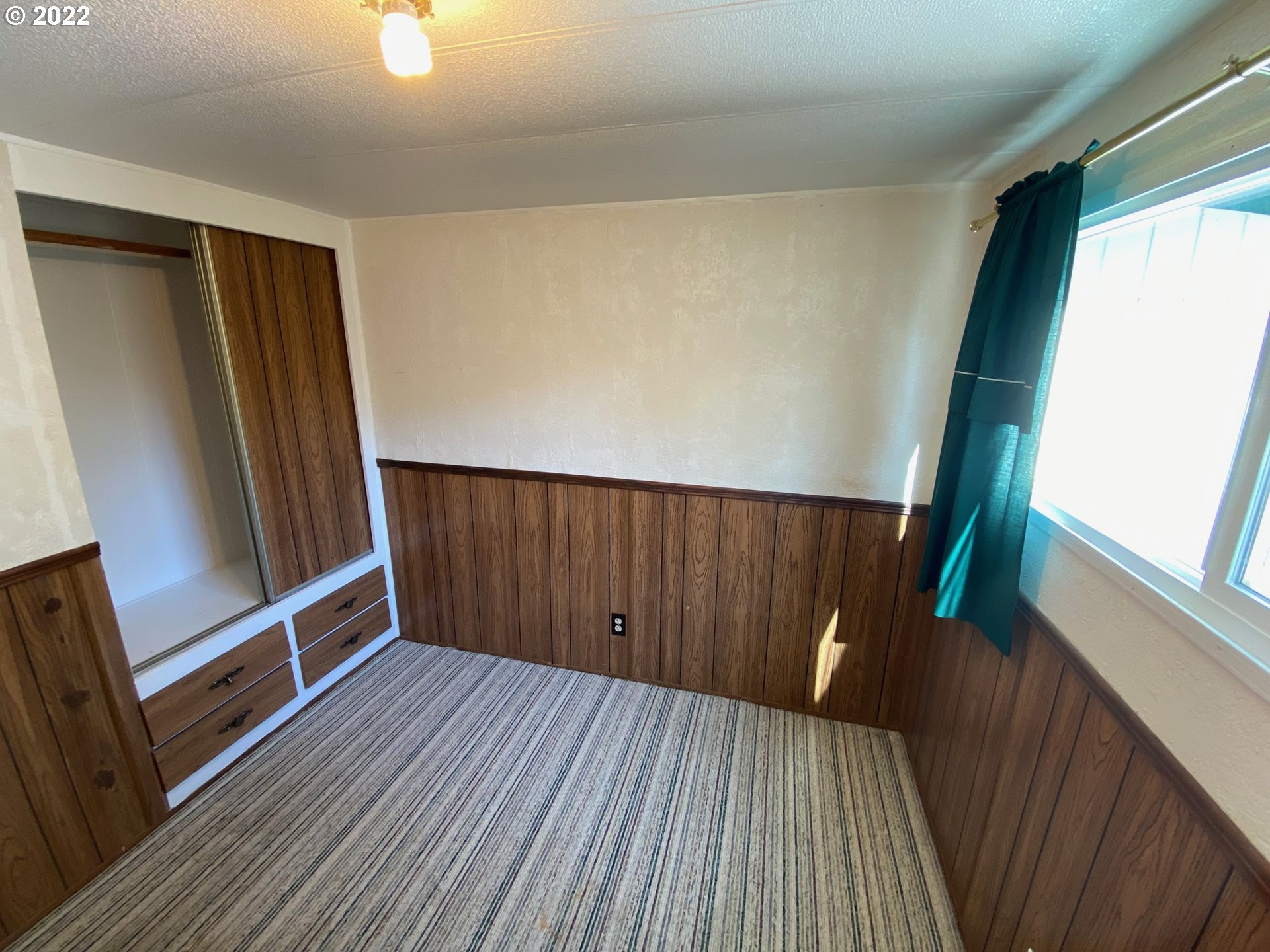 1475 Green Acres Road, Unit 165 Eugene, OR 97408 - Photo 8 of 14 a view of wooden floor in a hall