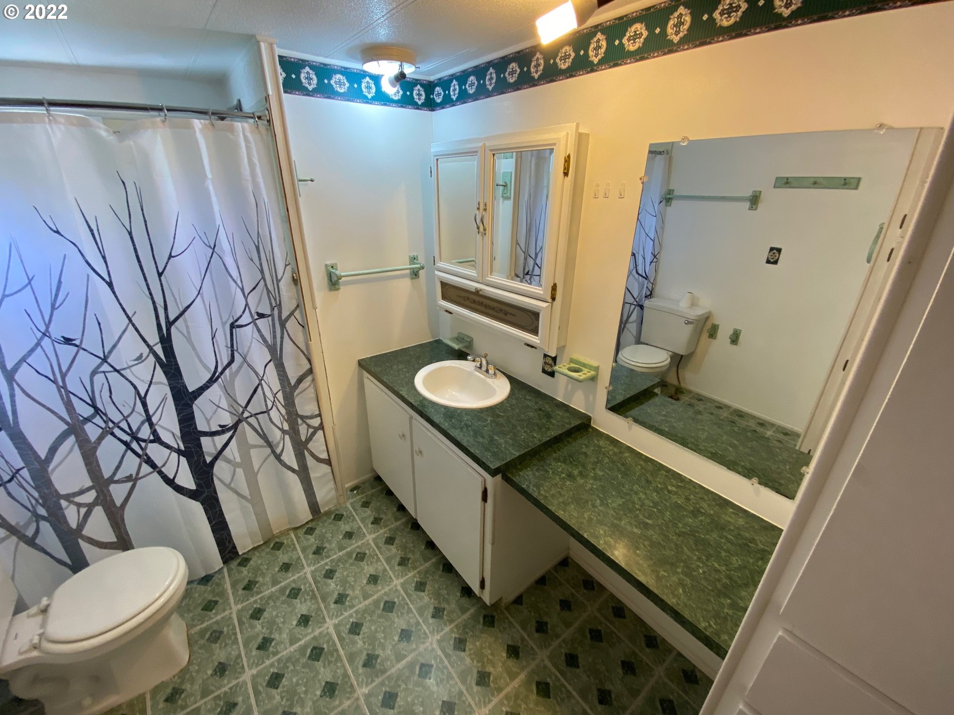 1475 Green Acres Road, Unit 165 Eugene, OR 97408 - Photo 9 of 14 a bathroom with a granite countertop sink and a mirror