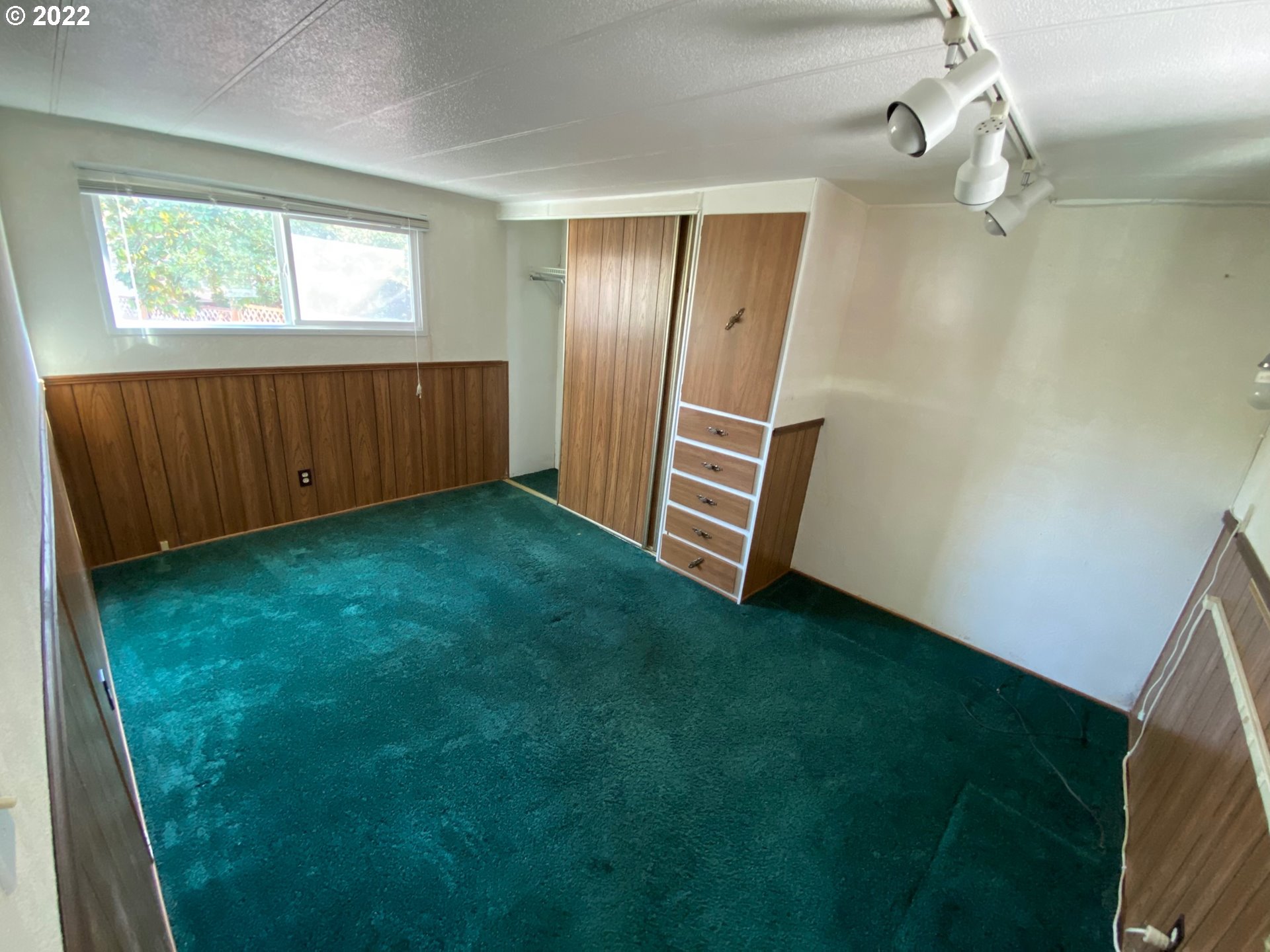 1475 Green Acres Road, Unit 165 Eugene, OR 97408 - Photo 10 of 14 an empty room with windows and stairs