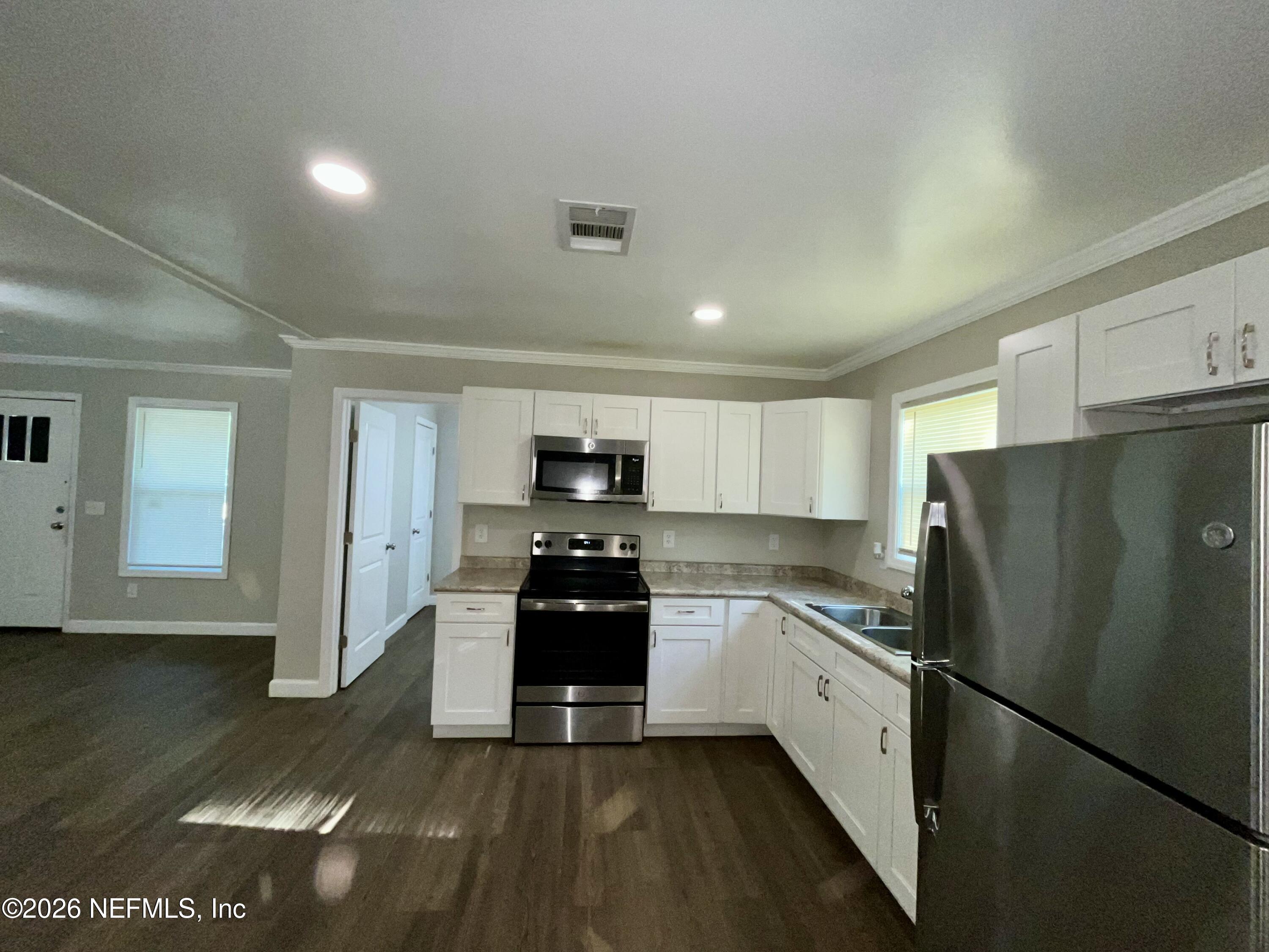 2017 Talladega Road Jacksonville, FL 32209 - Photo 20 of 34 a kitchen with stainless steel appliances a refrigerator sink and stove