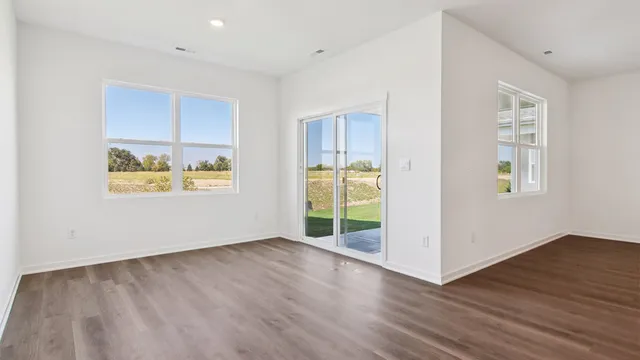 a view of kitchen with wooden floor electronic appliances and window