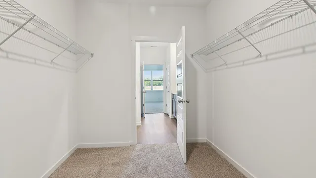 a sign of golf club on a wall under a white wall