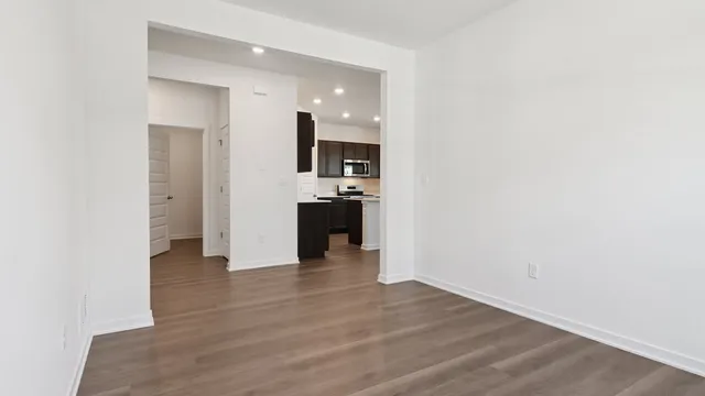 a view of a kitchen with wooden floor and electronic appliances