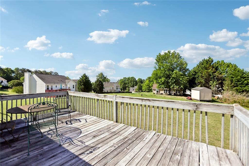 9720 Poole Road Villa Rica, GA 30180 - Photo 35 of 40 a view of balcony with wooden floor and fence
