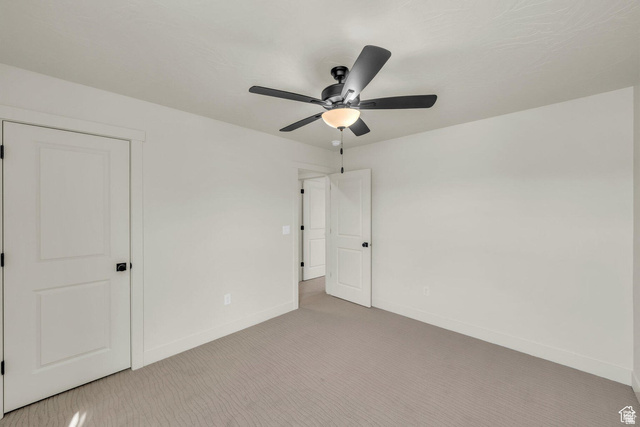 560 Aqua Cove St. George, UT 84790 - Photo 19 of 27 Unfurnished bedroom with light carpet and ceiling fan