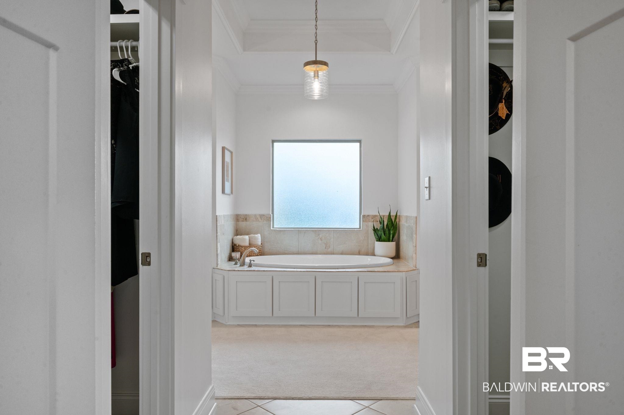 418 Fortune Drive Fairhope, AL 36532 - Photo 26 of 63 Bathroom with crown molding, a tray ceiling, a bath, and tile patterned floors