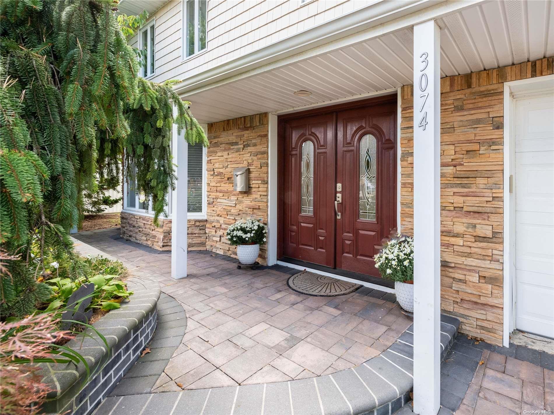 a view of a porch with chairs and potted plants