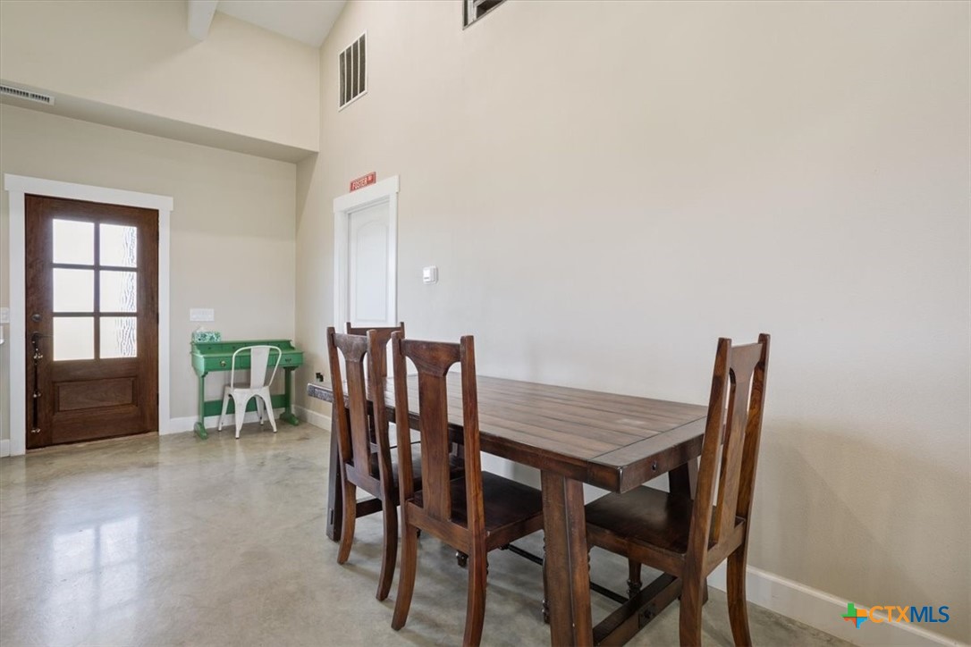 1490 Dos Hermanas Road Salado, TX 76571 - Photo 11 of 43 a view of a dining room with furniture and wooden floor