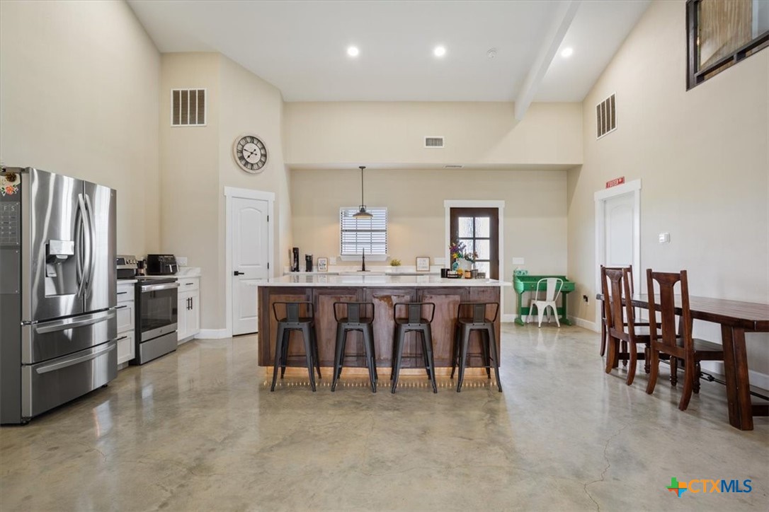 1490 Dos Hermanas Road Salado, TX 76571 - Photo 12 of 43 a large kitchen with a table and chairs