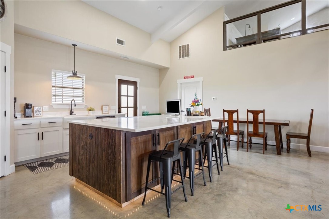 1490 Dos Hermanas Road Salado, TX 76571 - Photo 13 of 43 a kitchen with lots of wooden furniture appliances and furniture