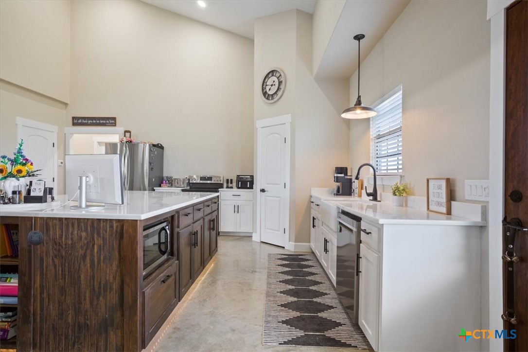 1490 Dos Hermanas Road Salado, TX 76571 - Photo 15 of 43 a large kitchen with kitchen island a sink stainless steel appliances and cabinets