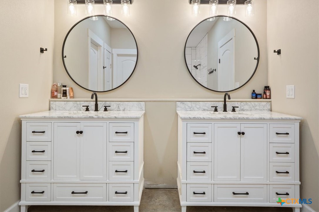 1490 Dos Hermanas Road Salado, TX 76571 - Photo 19 of 43 a bathroom with a double vanity sink and a mirror