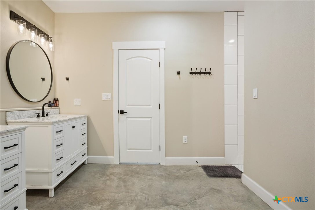 1490 Dos Hermanas Road Salado, TX 76571 - Photo 20 of 43 a bathroom with a double vanity sink and mirror