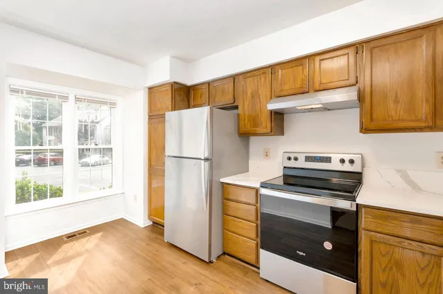 a kitchen with a refrigerator stove and a sink