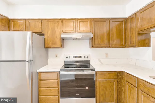 a kitchen with a refrigerator and a sink