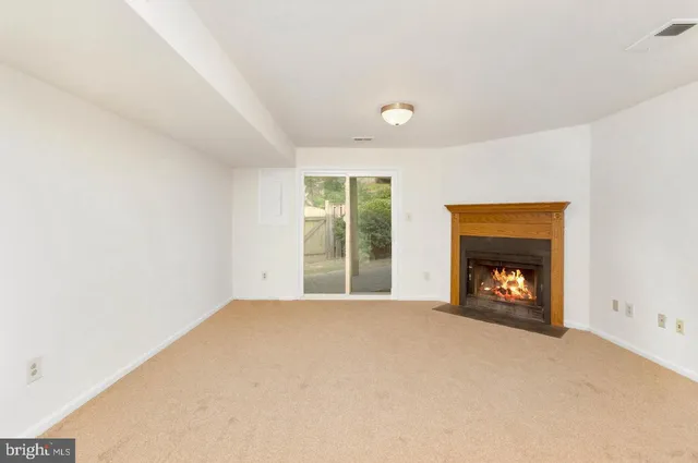a view of an empty room with a fireplace
