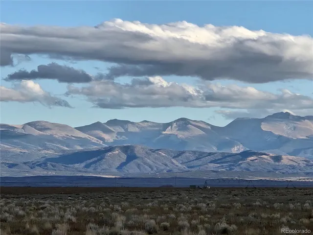 a view of house with mountains in the background
