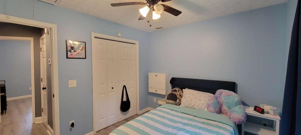 2140 Summerset Drive Monroe, GA 30656 - Photo 24 of 43 a bedroom with a bed and a chandelier