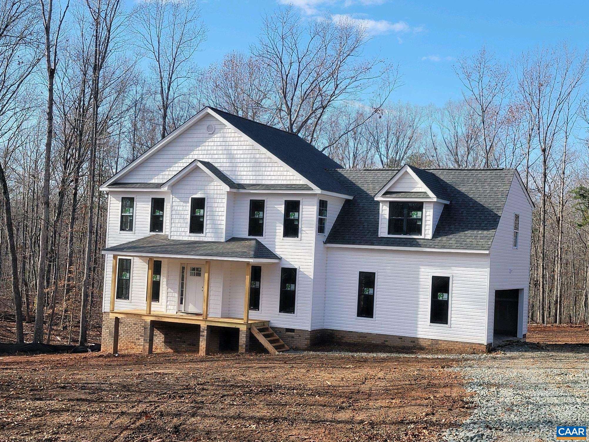 0 Martin Village Road, Unit 16E Louisa, VA 23093 - Photo 2 of 32 a view of a white house with a yard and large trees