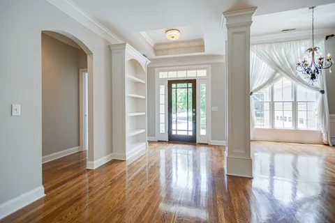 wooden floor in an empty room with a window