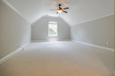 an empty room with a window and a ceiling fan