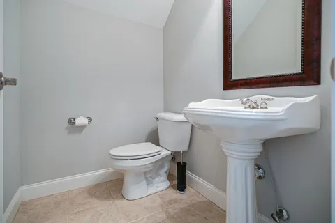 a bathroom with a sink toilet and a mirror