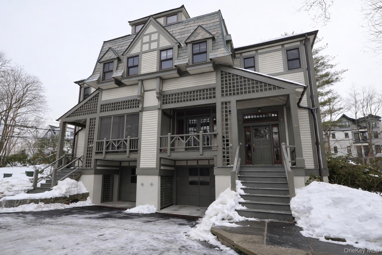a front view of a house with barbeque and outdoor seating
