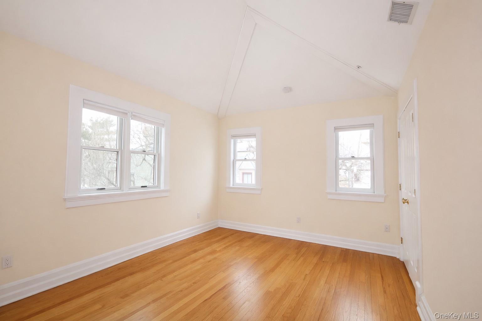 16 Clinton Avenue Dobbs Ferry, NY 10522 - Photo 11 of 26 an empty room with wooden floor and windows