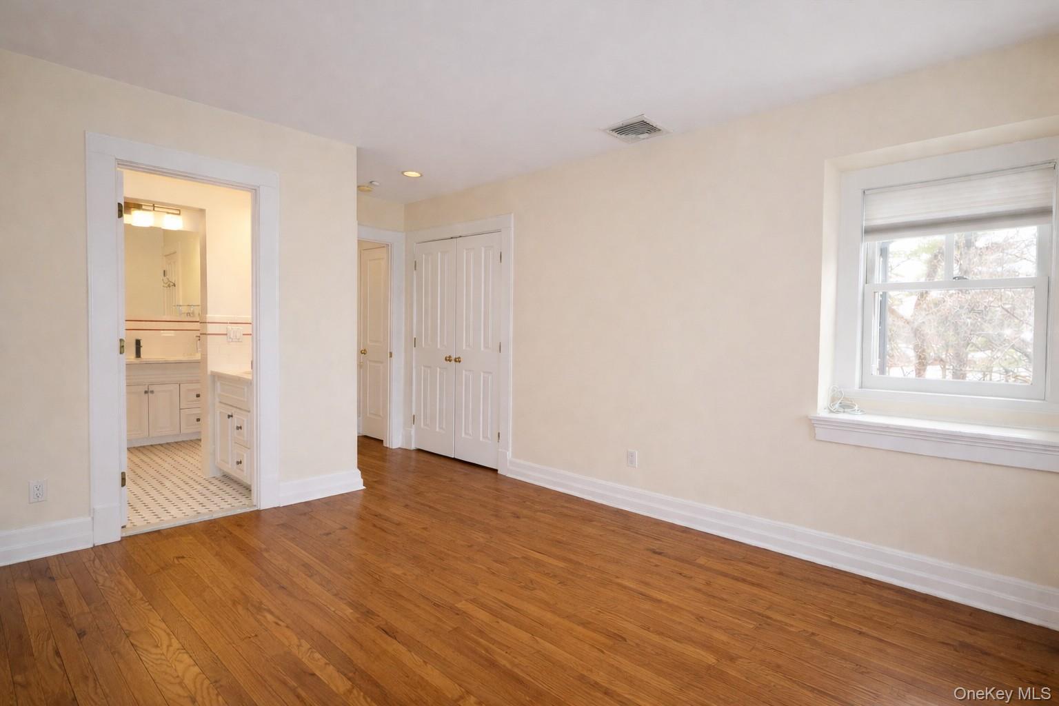 16 Clinton Avenue Dobbs Ferry, NY 10522 - Photo 12 of 26 a view of an empty room with wooden floor and a window